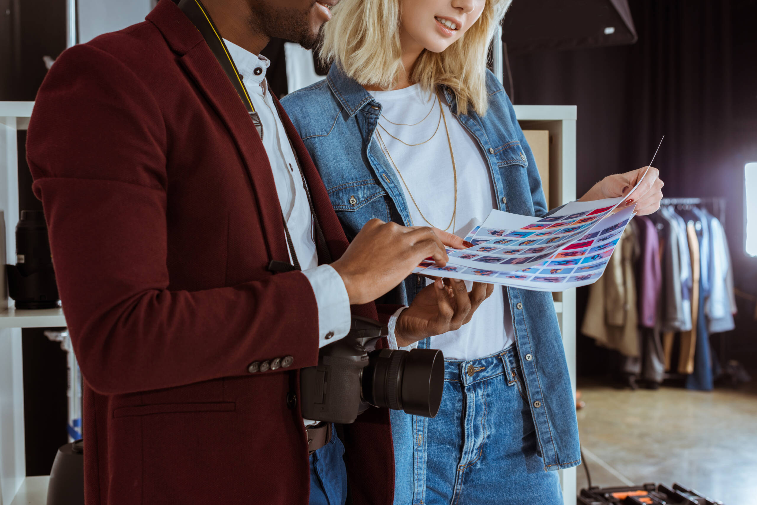 cropped shot of multiethnic photographers looking at portfolio together in studio - Jummp Marketing