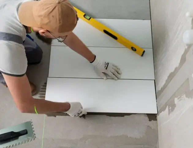 tiler-working-renovation-apartment_23-2149278631 tiler-working-renovation-apartment_23-2149278631